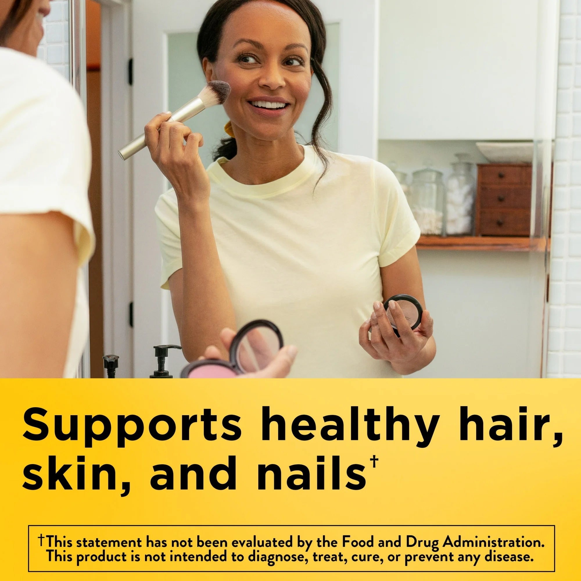Woman applying makeup in front of a mirror with text about product benefits. Biotin supplement supporting hair, skin, and nail health