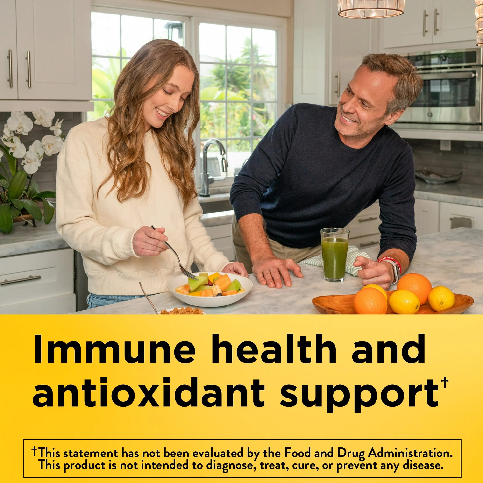 Man and woman in a kitchen with fruits and a glass of juice, promoting immune health and antioxidant support. Nature Made USP‑verified chewable Vitamin C 1000 mg bottle